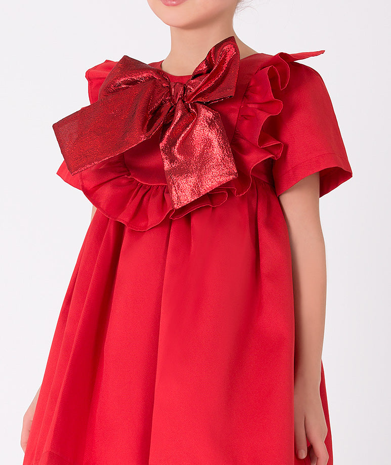 Elegant red girls' dress with statement bow and silver boots – Fashion-forward dress with a bold metallic bow for a unique holiday look