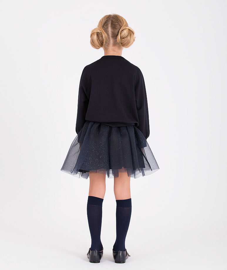 Navy glitter tulle skirt matched with a navy sweatshirt and floral detail