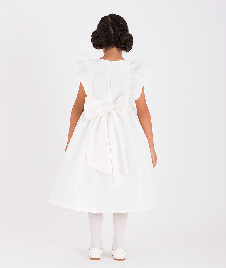 White girls' dress with delicate ruffle accents on the sleeves