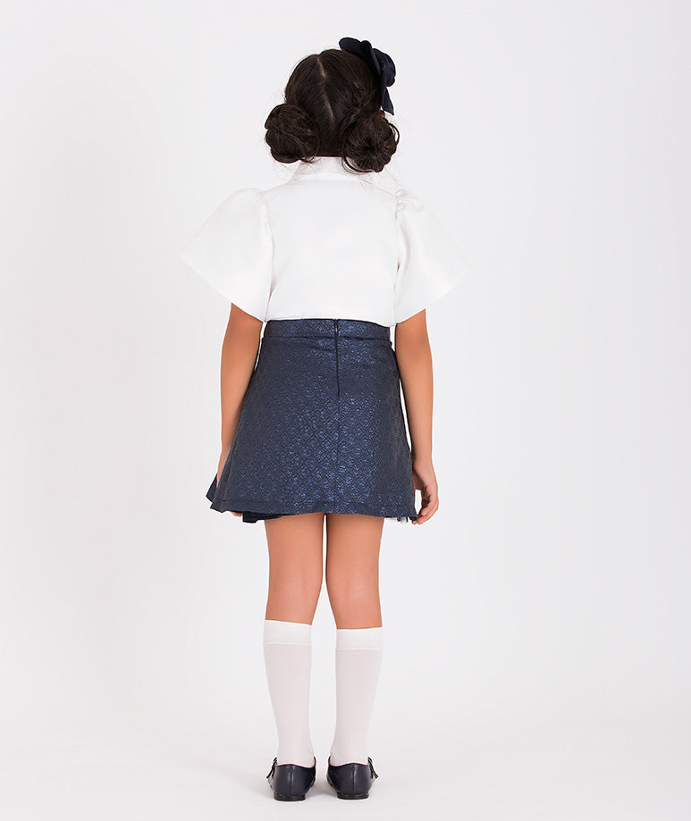 Navy bow skirt and white balloon-sleeved blouse combo