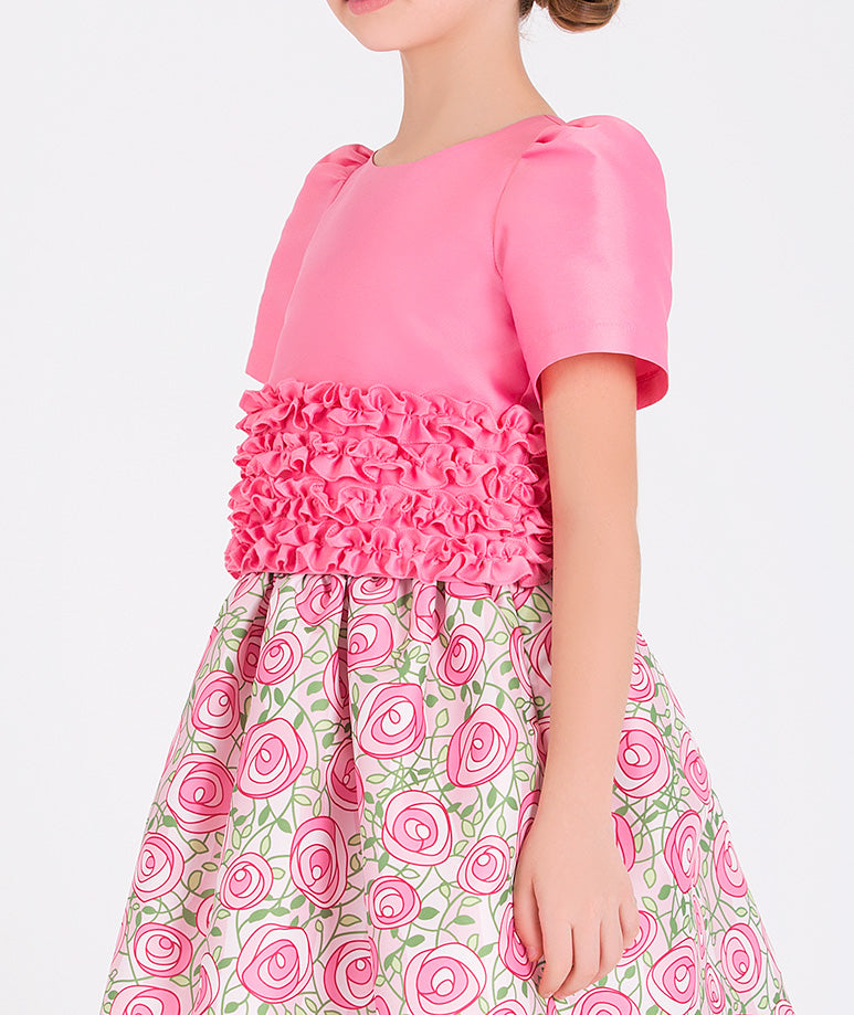 a pink blouse with a ruched waist and a charming pink rose-printed skirt